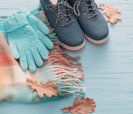 blue winter shoes and gloves on blue wooden backgroundの写真素材