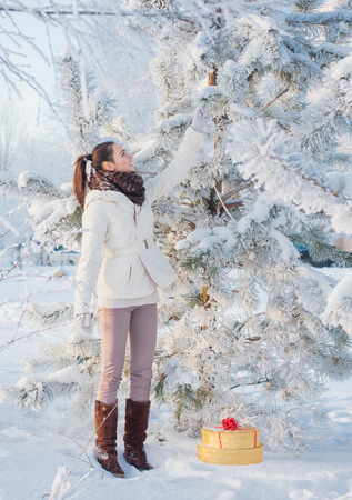 happy beautiful girl in winter forestの写真素材