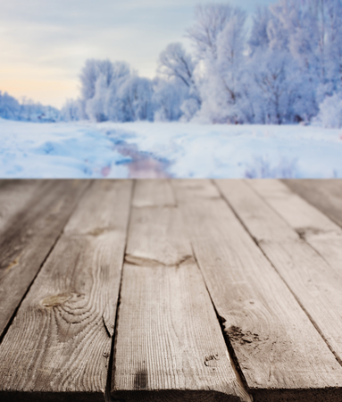 rustic wooden table and winter landscapeの写真素材