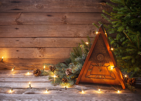 vintage clock with Christmas tree on wooden backgroundの写真素材
