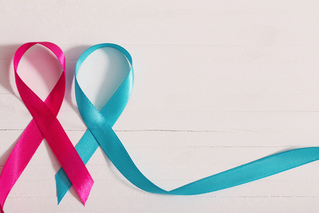 blue and pink ribbon on white wooden backgroundの写真素材
