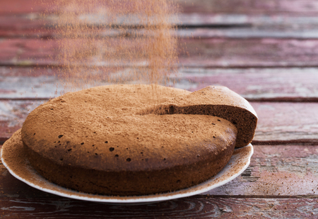 chocolate sponge cake on old wooden backgroundの写真素材