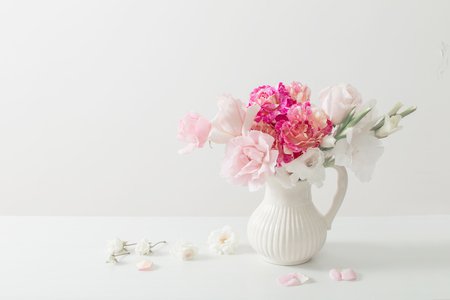 pink and white flowers in vase on white backgroundの写真素材