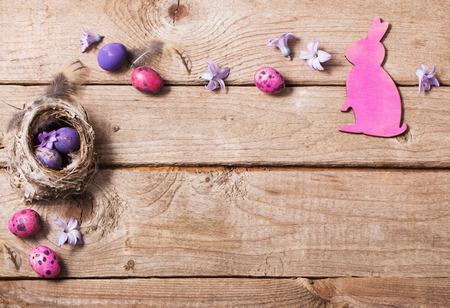 Easter eggs in nest on wooden backgroundの写真素材