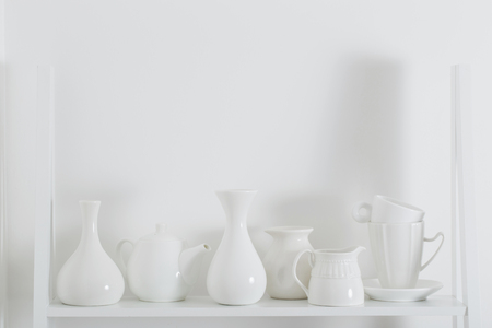 white dishvare on wooden shelfの写真素材