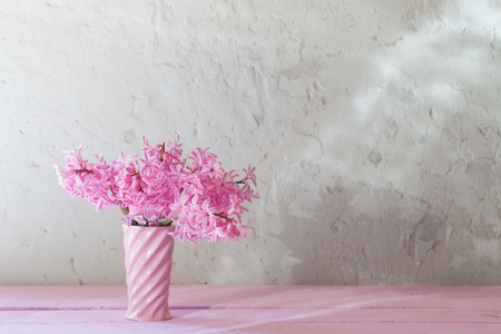 pink hyacinths in vase on white backgroundの写真素材