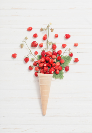 waffle cone with strawberries on wooden backgroundの写真素材