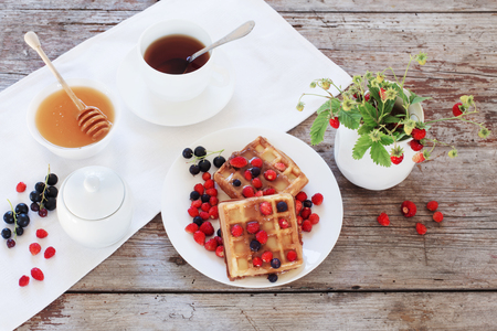 breakfast with berries on old wooden tableの写真素材
