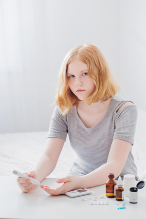 girl teenager measures blood sugar levelの写真素材