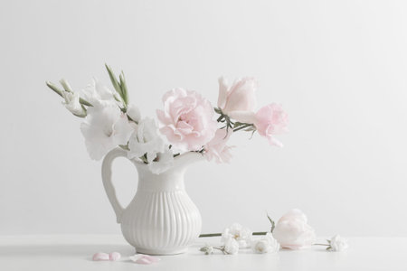pink and white flowers in vase on white backgroundの写真素材