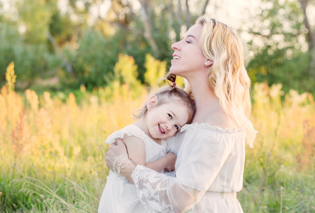 mother and daughter on summer meadowの写真素材