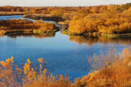 beautiful autumn landscape with river and treesの写真素材