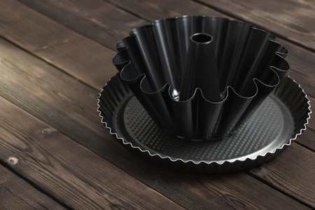 metal baking dish of cakes on old wooden background