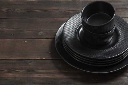 black plates on old  wooden backgroundの写真素材