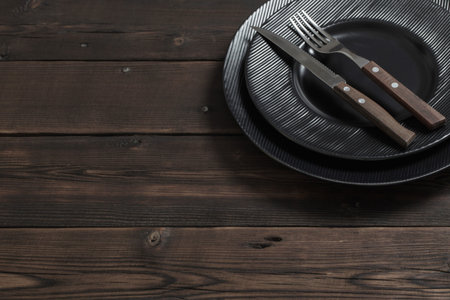 black plates on old  wooden background