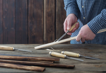 carpenter working with tools on wooden background