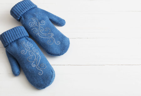 blue mittens on white wooden backgroundの写真素材