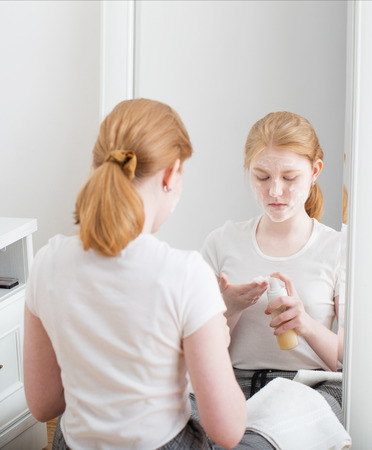 fair-haired teen girl puts on  face maskの写真素材
