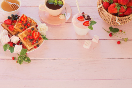 breakfast with strawberries on pink wooden tableの写真素材