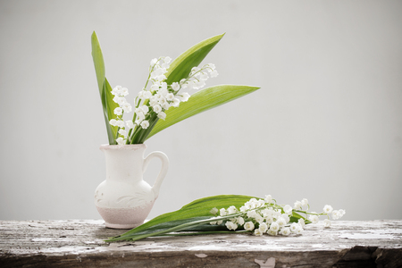 beautiful spring flowers on old wooden tableの写真素材