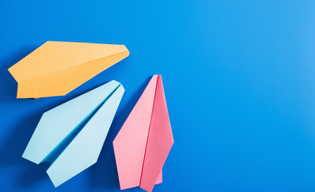paper plane on blue color backgroundの写真素材