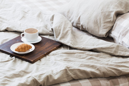coffee on wooden  tray on the bed in bedroom