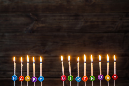 birthday candles on dark wooden backgroundの写真素材