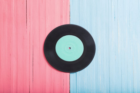 Music records on pink and blue wooden background. Retro music concept
