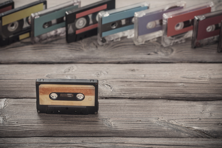 Old plastic cassette on wooden background. Retro music conceptの写真素材