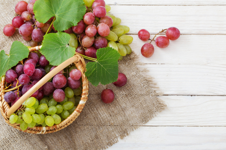 pink and green grape on wooden backgroundの写真素材