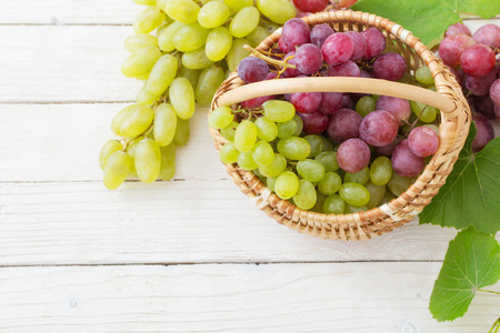 pink and green grape on wooden backgroundの写真素材