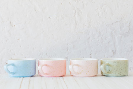 modern ceramic cups on background white wall