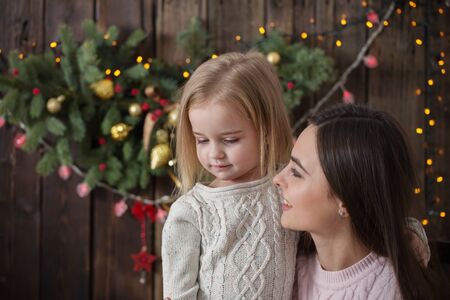 happy family with christmas decorations on dark wooden backgroundの写真素材