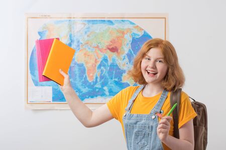 teen girl stands at  geographical mapの写真素材
