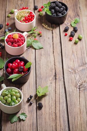 different berries on old wooden backgroundの写真素材