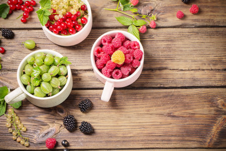different berries on old wooden background