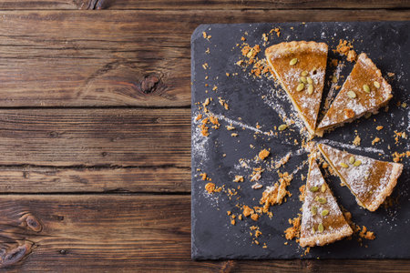 pieces of pumpkin pie on old wooden table