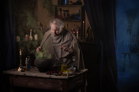 elderly alchemist monk brews  magic potion