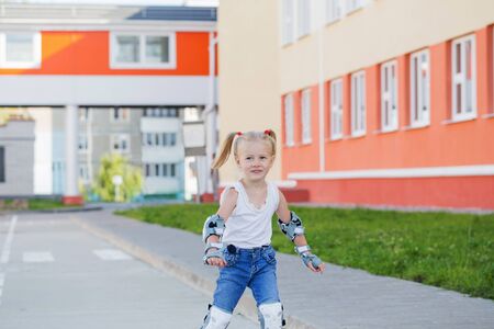 little girl rides inline skatesの写真素材