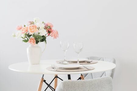 served table with  bouquet of roses in scandinavian styleの写真素材