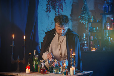 portrait of  wizard with burning candles and magic potions