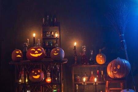 Halloween decoration with pumpkins and magic potions indoorの写真素材