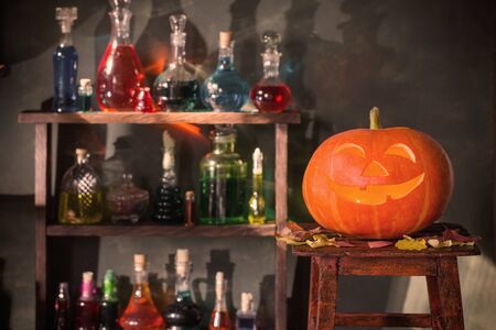 Halloween decoration with pumpkins and magic potions indoorの写真素材