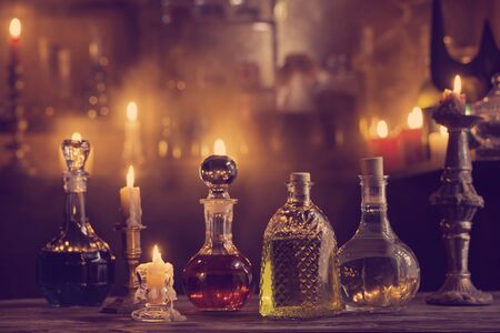 magic potions in bottles on wooden backgroundの写真素材