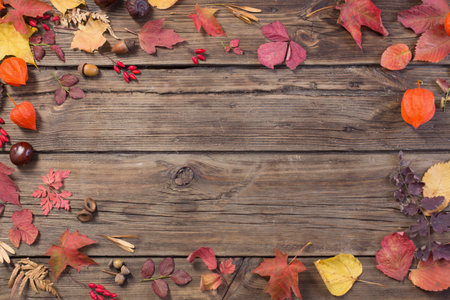 autumn leaves on dark old wooden background