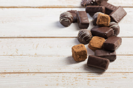 chocolate candy on white wooden background