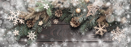 fir branches with Christmas decor on old dark wooden backgroundの写真素材