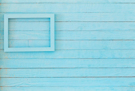 wooden frame on background old blue wall