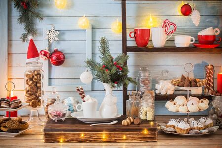 Christmas bar cacao decoration with cookies and sweets on blue wooden background in vintage styleの写真素材