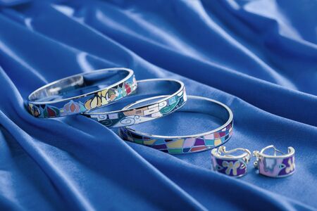 Earrings and bracelet on blue cloth. Classic blue color 2020.の写真素材